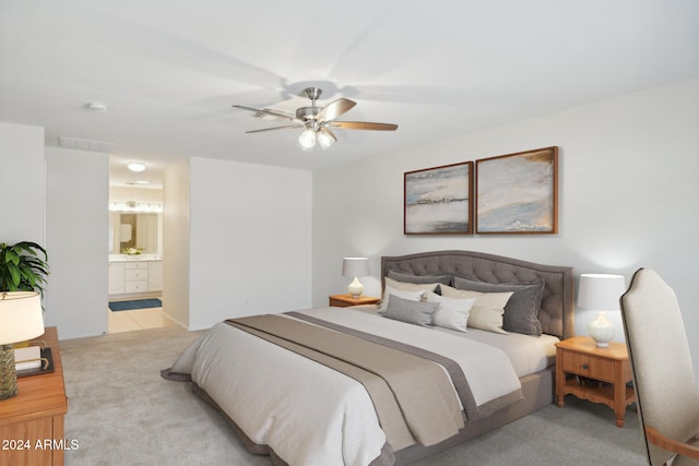 carpeted bedroom featuring ensuite bath and ceiling fan