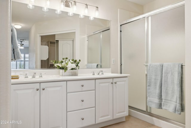 bathroom featuring tile patterned flooring, vanity, a shower with door, and ceiling fan