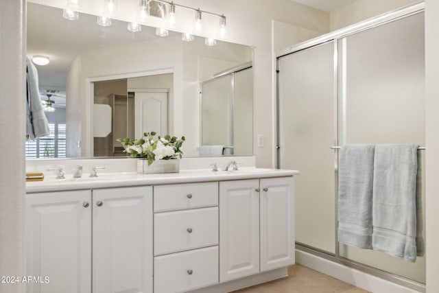15016 W Monterey Way, Goodyear, AZ 85395 - bathroom with double vanity, a stall shower, and a sink