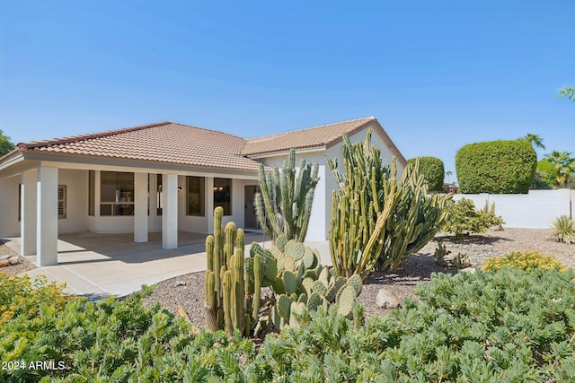 15016 W Monterey Way, Goodyear, AZ 85395 - back of property featuring stucco siding, a tile roof, fence, and a patio area