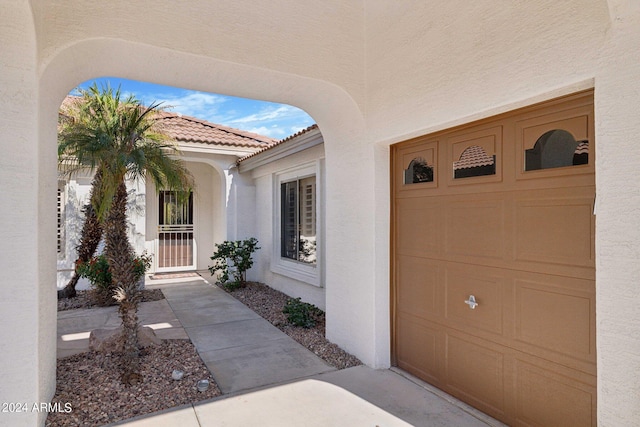 15016 W Monterey Way, Goodyear, AZ 85395 - entrance to property with a tile roof, a garage, and stucco siding
