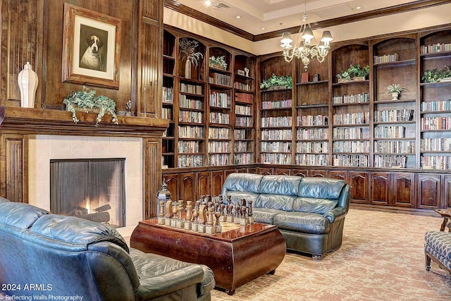 sitting room with a tiled fireplace, built in features, wooden walls, and a chandelier