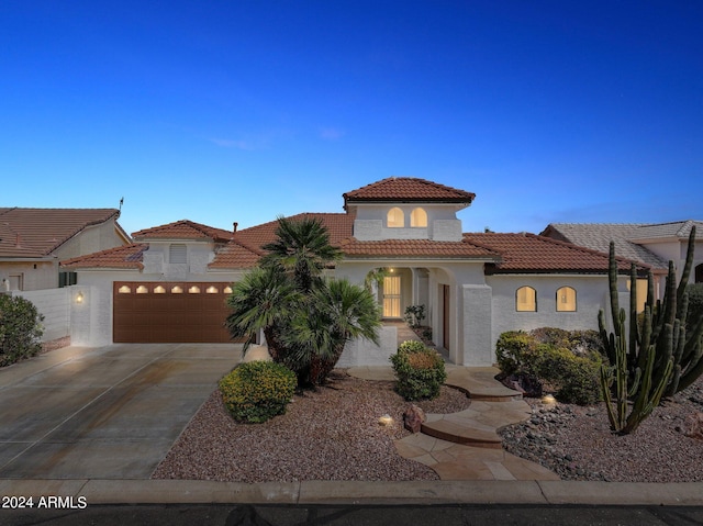 15016 W Monterey Way, Goodyear, AZ 85395 - mediterranean / spanish house with stucco siding, a garage, a tiled roof, and driveway