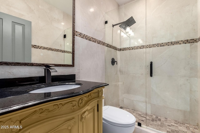 bathroom featuring vanity, toilet, and a shower with door