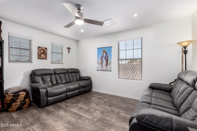 living room with dark wood-type flooring and ceiling fan