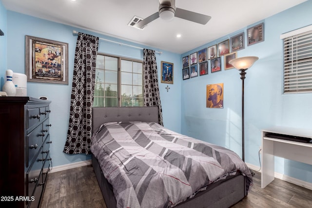 bedroom with dark hardwood / wood-style floors and ceiling fan