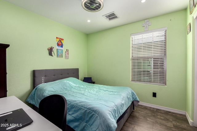 bedroom with dark hardwood / wood-style floors