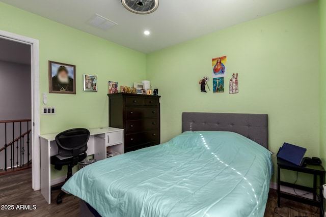 bedroom with dark hardwood / wood-style floors