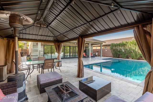 view of pool featuring an outdoor fire pit and a patio area