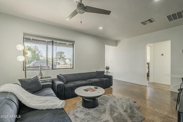 living room featuring concrete flooring and ceiling fan