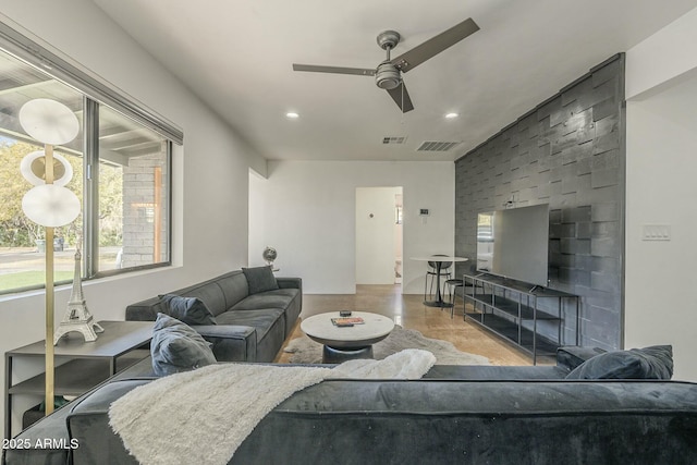living room with concrete floors and ceiling fan