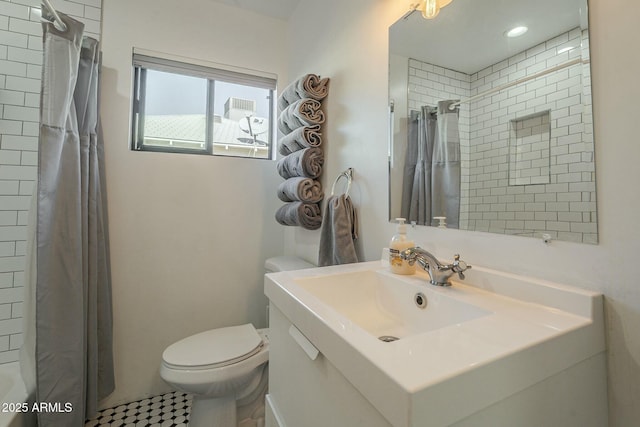 bathroom featuring walk in shower, vanity, and toilet