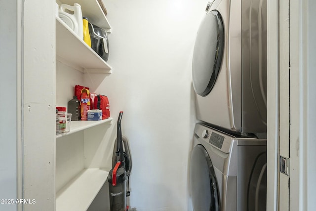 laundry room featuring stacked washer / drying machine