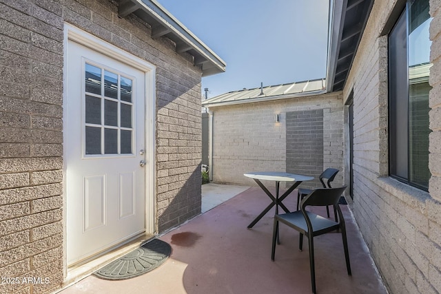 view of exterior entry featuring a patio