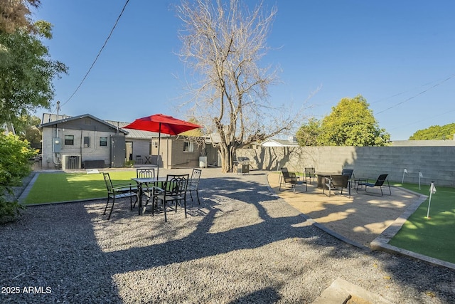 view of yard with a patio and central AC unit