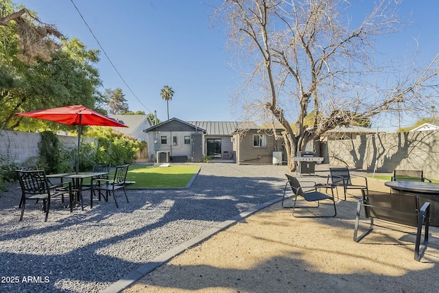 back of house with a patio and a lawn