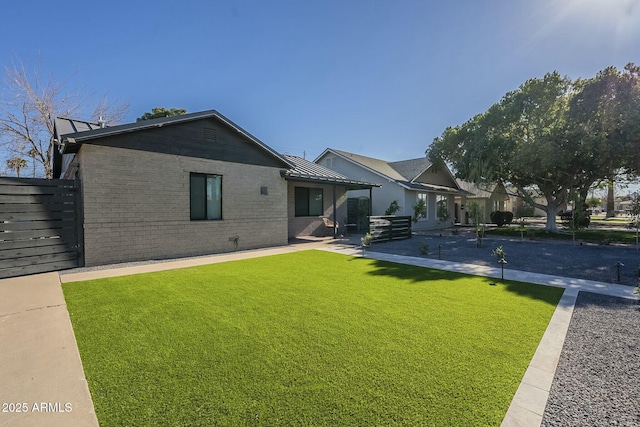 rear view of house featuring a yard and a patio