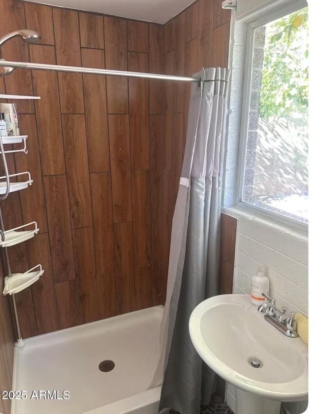 bathroom with sink and a shower with shower curtain