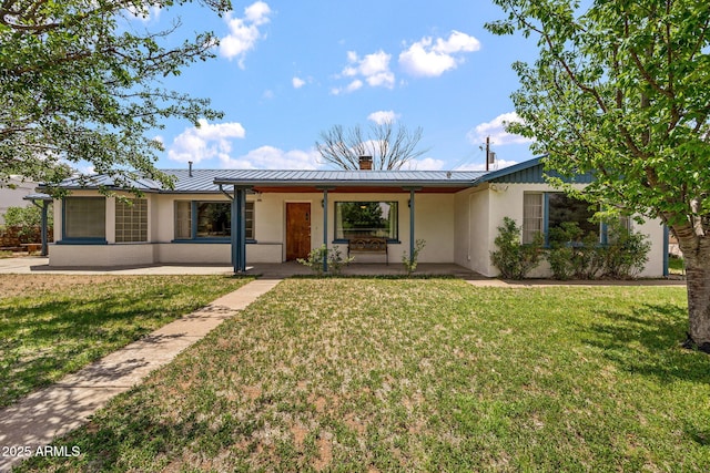 126 E Cattle Ln, Taylor, AZ 85939 - ranch-style house with a standing seam roof, a metal roof, a front yard, stucco siding, and a chimney