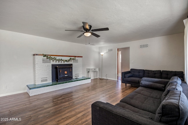 126 E Cattle Ln, Taylor, AZ 85939 - living area with ceiling fan, wood finished floors, a brick fireplace, and a textured ceiling