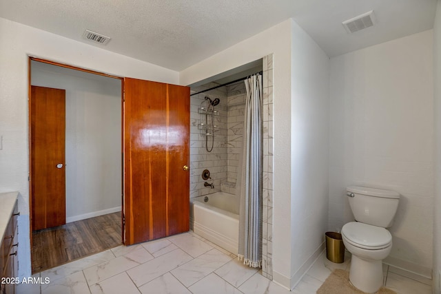 126 E Cattle Ln, Taylor, AZ 85939 - bathroom featuring shower / tub combo, marble finish floors, vanity, and a textured ceiling