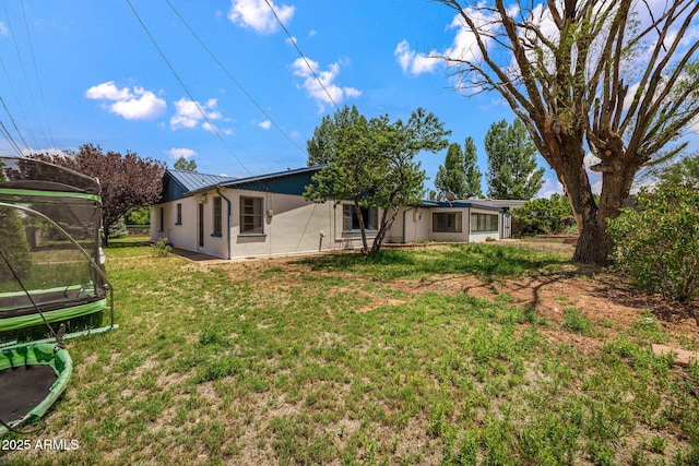 126 E Cattle Ln, Taylor, AZ 85939 - rear view of property with a trampoline, a metal roof, a yard, and a standing seam roof