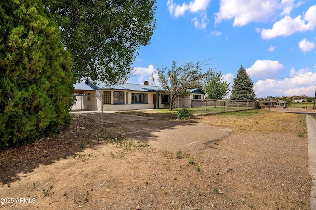 126 E Cattle Ln, Taylor, AZ 85939 - back of house with dirt driveway, an attached carport, a metal roof, a standing seam roof, and a chimney
