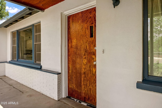 126 E Cattle Ln, Taylor, AZ 85939 - view of exterior entry featuring stucco siding and brick siding