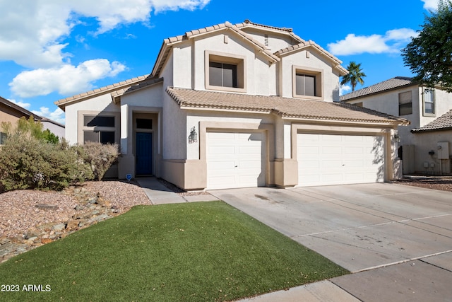 view of front of house featuring a garage and a front lawn