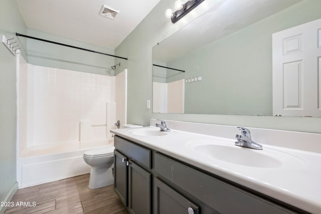 full bathroom with vanity, bathtub / shower combination, toilet, and hardwood / wood-style flooring