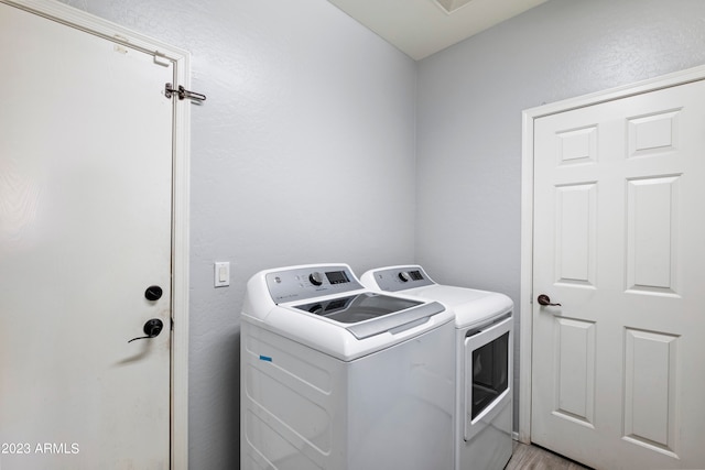 washroom featuring washer and clothes dryer