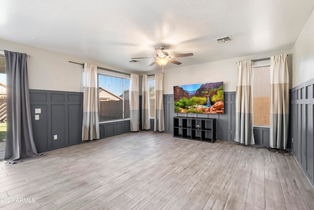 unfurnished living room with ceiling fan and light hardwood / wood-style flooring