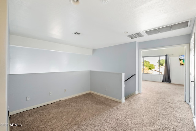 unfurnished room with light carpet