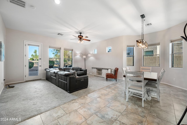 living room featuring carpet floors, visible vents, and a healthy amount of sunlight