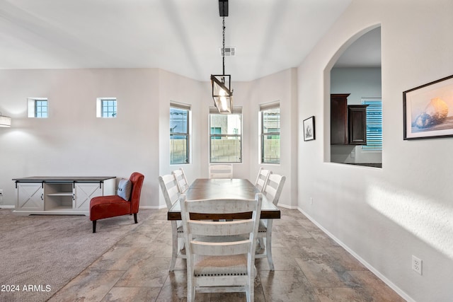 dining area featuring arched walkways, visible vents, and baseboards