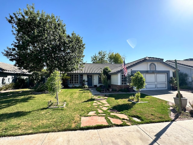 view of front of house with a front lawn and a garage