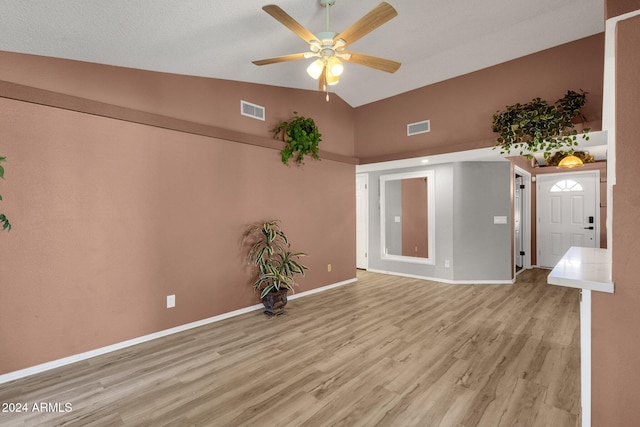 interior space with light hardwood / wood-style flooring, high vaulted ceiling, and ceiling fan