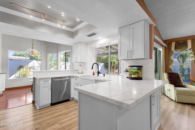 kitchen featuring white cabinetry, kitchen peninsula, dishwasher, and a textured ceiling