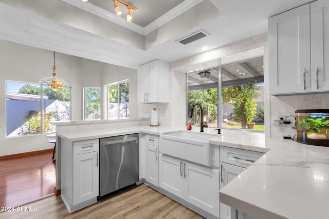 kitchen with kitchen peninsula, white cabinets, stainless steel dishwasher, light hardwood / wood-style flooring, and plenty of natural light