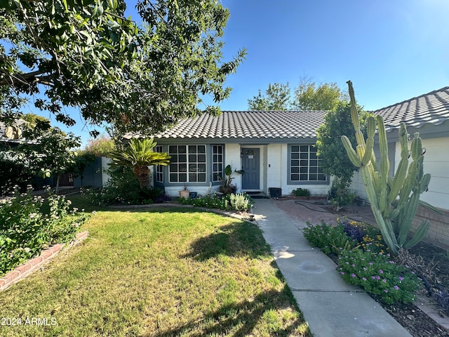 ranch-style house with a front lawn