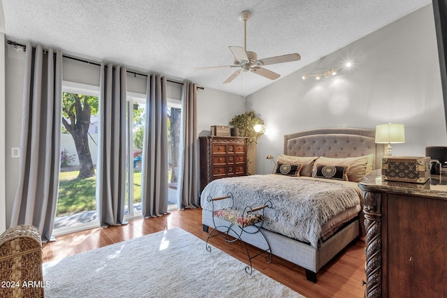 bedroom featuring ceiling fan, a textured ceiling, light wood-type flooring, and access to exterior