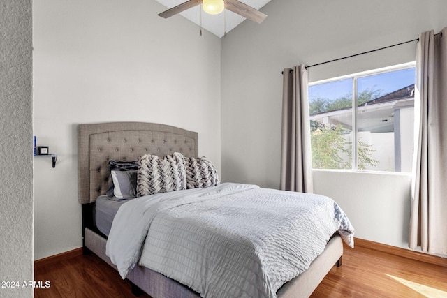 bedroom featuring ceiling fan, hardwood / wood-style flooring, and lofted ceiling