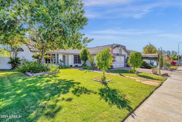 view of front facade with a front yard and a garage