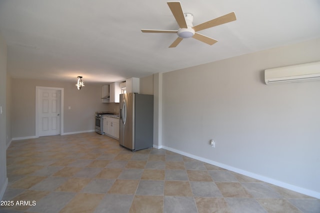 3640 W Garfield St, Phoenix, AZ 85009 - kitchen featuring appliances with stainless steel finishes, a wall mounted air conditioner, a ceiling fan, white cabinets, and baseboards