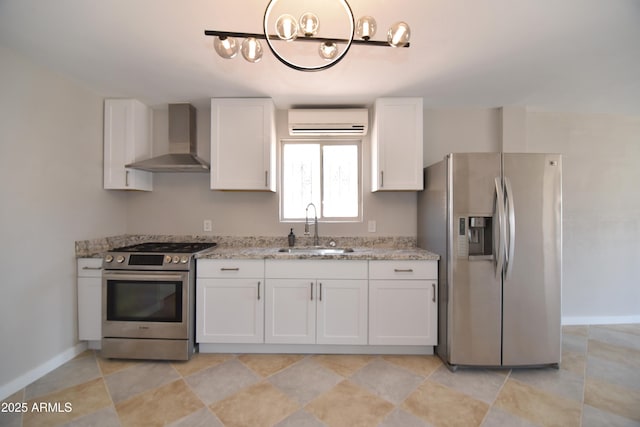 3640 W Garfield St, Phoenix, AZ 85009 - kitchen with appliances with stainless steel finishes, a sink, wall chimney range hood, an AC wall unit, and a chandelier