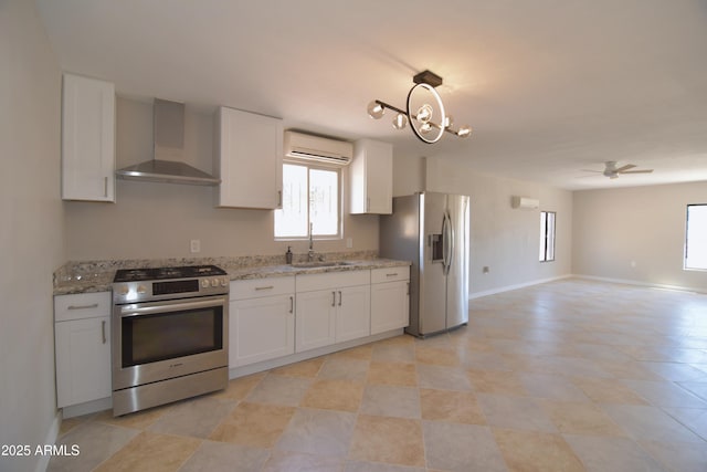 3640 W Garfield St, Phoenix, AZ 85009 - kitchen with wall chimney range hood, stainless steel appliances, a sink, a wall mounted air conditioner, and plenty of natural light