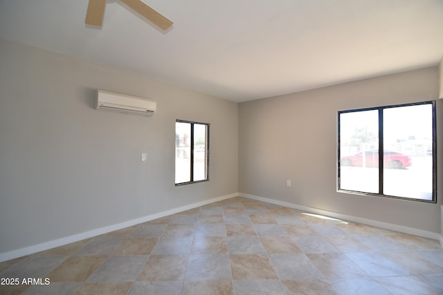 3640 W Garfield St, Phoenix, AZ 85009 - spare room with a wall mounted air conditioner, ceiling fan, baseboards, and light tile patterned floors