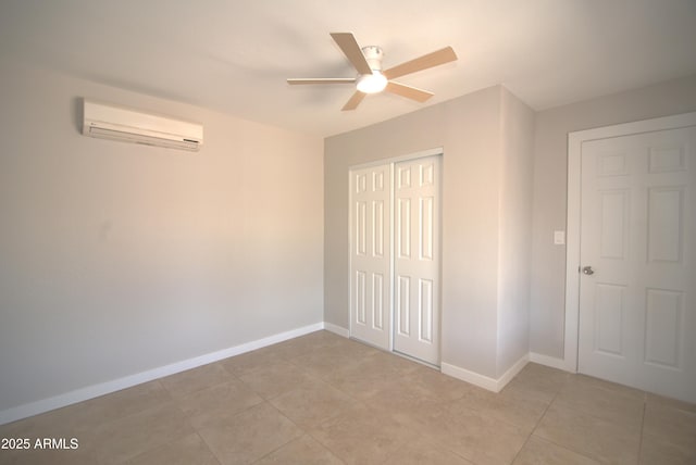 3640 W Garfield St, Phoenix, AZ 85009 - unfurnished bedroom featuring an AC wall unit, a closet, baseboards, light tile patterned floors, and a ceiling fan