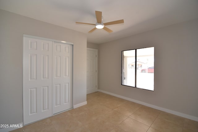 3640 W Garfield St, Phoenix, AZ 85009 - unfurnished bedroom with a closet, baseboards, light tile patterned floors, and ceiling fan