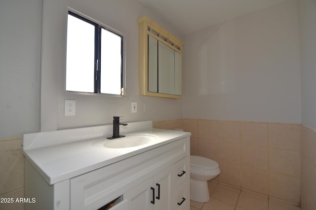 3640 W Garfield St, Phoenix, AZ 85009 - bathroom with tile walls, vanity, toilet, wainscoting, and tile patterned flooring